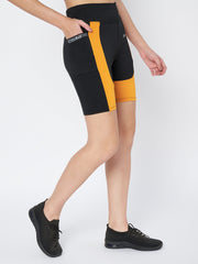 Side view of a model in Waylene's black and orange sports shorts, depicting the stripe detail and high-waist fit, suitable for sports and fitness activities.
