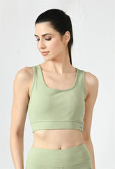Close-up of Waylene light green (pista green) sports bra showing racerback design and stretchable straps - front view