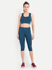 Frontal view of a model in Waylene's teal blue capri and sports bra set, standing straight to show the uniform color and texture, suitable for yoga and fitness enthusiasts.