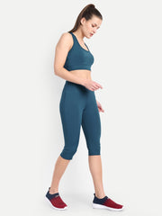Side view of a model in Waylene's teal blue capri and sports bra set, emphasizing the sleek design and body-hugging fit, ideal for active movements.