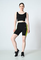 model is showcasing waylene's colour block gym shorts for women black and parrot green