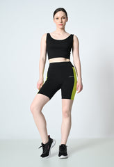 model is showcasing waylene's colour block gym shorts for women black and parrot green