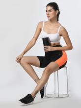 Waylene Black & Orange Colorblock High-Performance Shorts with Pocket, side view on model seated.