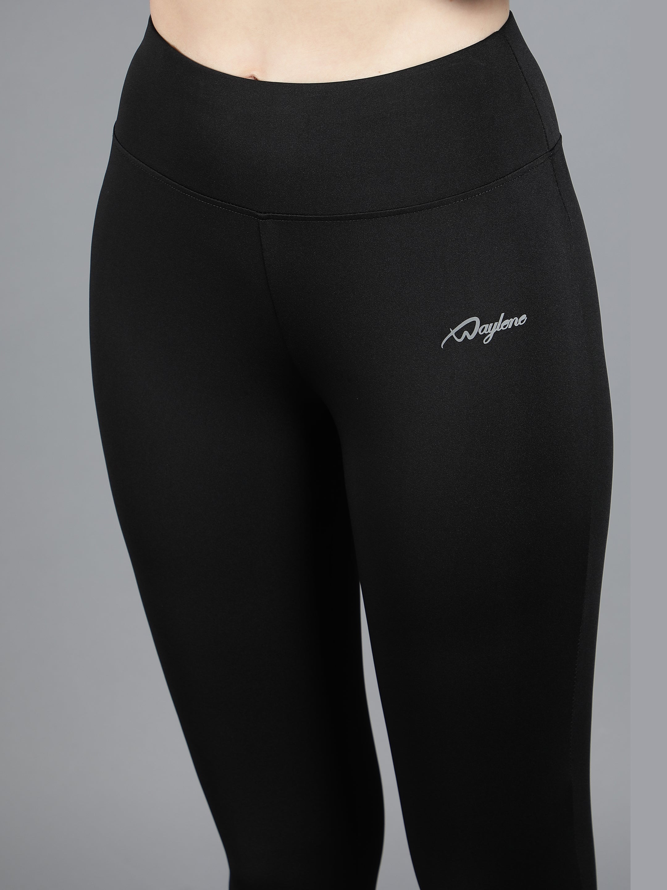 Close-up of Waylene Black Tights, showing high waist and logo detail for gym and yoga.