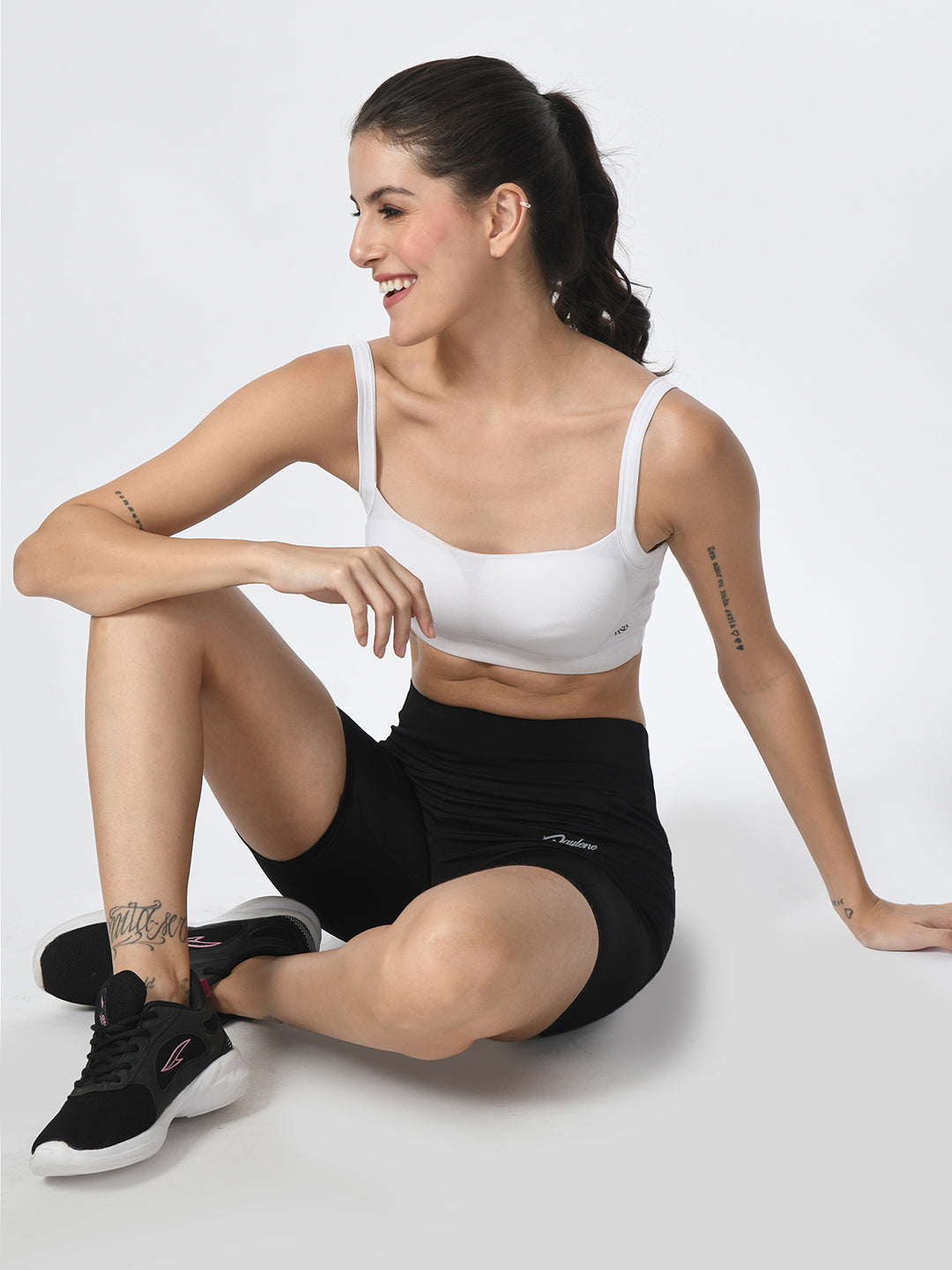 Waylene Black Shorts, lifestyle image with model seated, highlighting versatility for gym and casual wear.