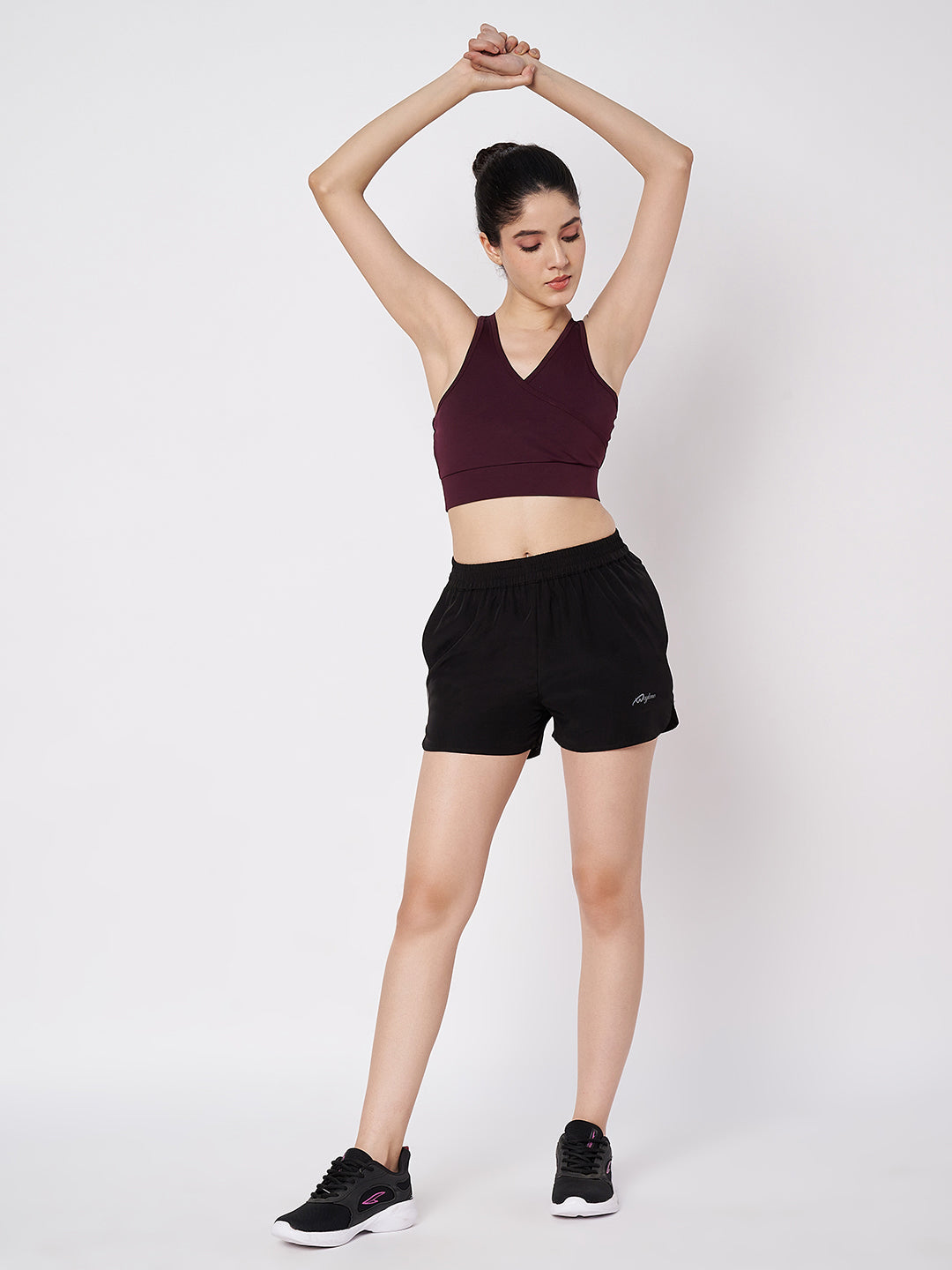 Waylene Black Polyester Shorts styled with a sports bra, demonstrating flexibility for exercise.