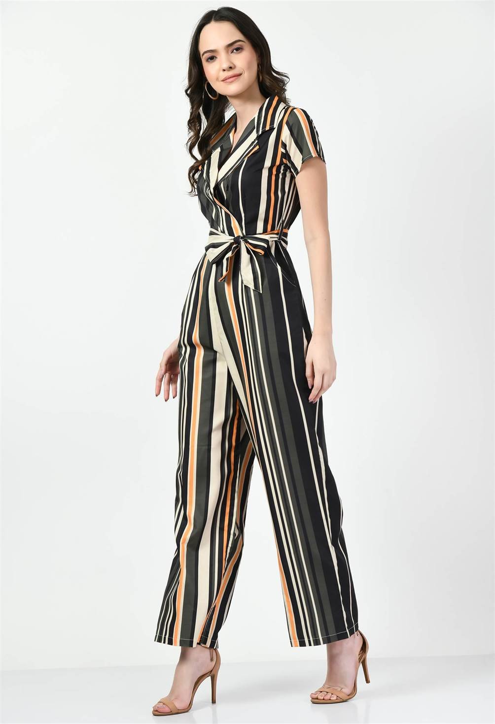 Model confidently poses in Waylene's multi-color striped jumpsuit with a collared top and belted waist, hands on hips, against a plain white backdrop.